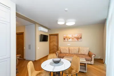 a living room with a couch and a table at Sun Sonata Apartments 3 in Druskininkai