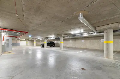 an empty parking garage with a car parked in it at Sun Sonata Apartments 3 in Druskininkai