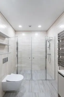 a white bathroom with a shower and a toilet at Sun Sonata Apartments 3 in Druskininkai