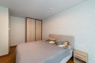 a bedroom with a bed in a room at Sun Sonata Apartments 3 in Druskininkai