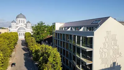 an office building with a drawing on the side of it at Light- Filled Flat with Balcony in a Heart of Kaunas in Kaunas