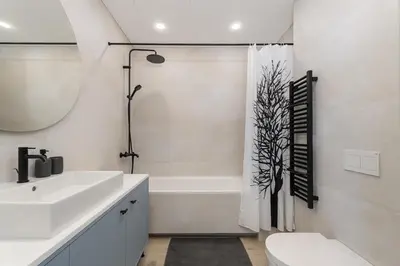 a bathroom with a sink and a tub and a toilet at Light- Filled Flat with Balcony in a Heart of Kaunas in Kaunas