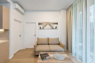 a living room with a couch and a table at Sun Sonata Apartments 1 in Druskininkai