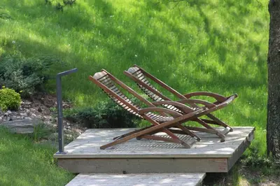 a bench sitting on a wooden platform in the grass at Kernavės Pajauta in Kernavė