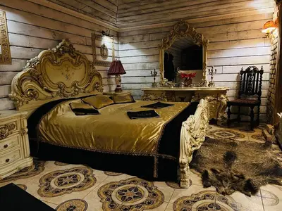 a bedroom with a large bed and a mirror at Apartment Host 4 in Kaunas
