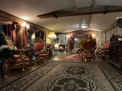 a large living room with chairs and a rug at Apartment Host 4 in Kaunas
