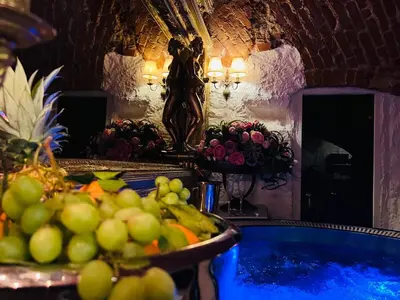 a room with a tub of fruit and a statue at Host 1 apartment in Kaunas