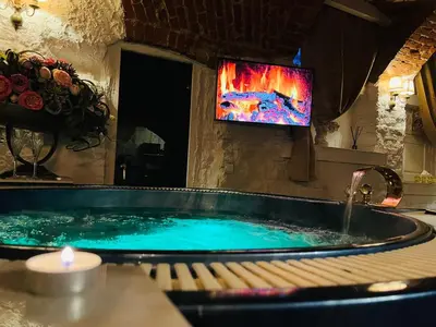 a bath tub with a tv in a room at Host 1 apartment in Kaunas