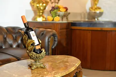 a bottle of wine in a holder on a table at Host 1 apartment in Kaunas