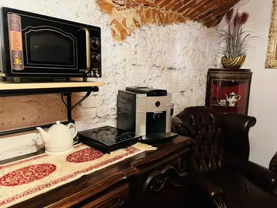 a microwave sitting on top of a wooden table at Host 1 apartment in Kaunas