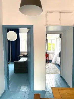 a room with a blue door and a living room at Uzupio4 Old Town House in Vilnius