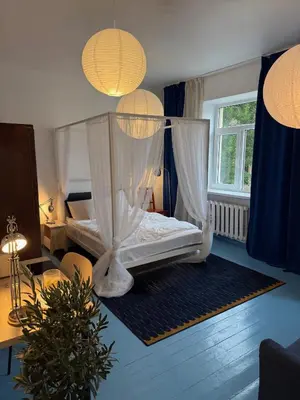a bedroom with a bed with a canopy at Uzupio4 Old Town House in Vilnius
