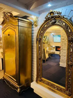 a large gold mirror on a wall in a room at Apartment Host 2 in Kaunas