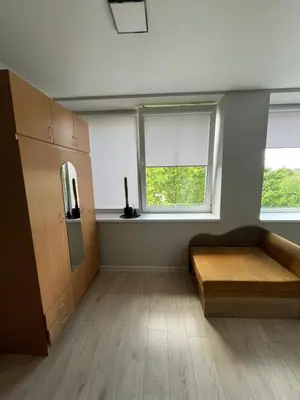 a room with a bed and two windows at Apartamentai 1 in Raseiniai