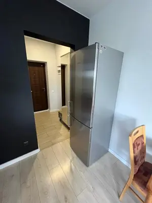 a kitchen with a stainless steel refrigerator in a room at Apartamentai 1 in Raseiniai