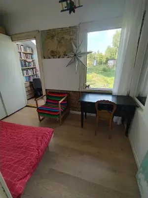 a bedroom with a desk and a chair and a window at Hilltop view - 2 bedroom house with garden bbq - private parking - 12min to Uzupis anytime in Vilnius