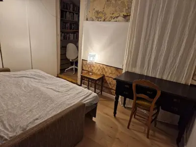 a bedroom with a desk and a bed and a desk and chair at Hilltop view - 2 bedroom house with garden bbq - private parking - 12min to Uzupis anytime in Vilnius