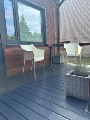 two white chairs and a table on a deck at Marvelės 30 Lofts in Kaunas