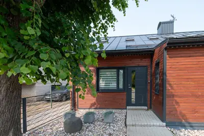 a wooden house with a black door at Marvelės 30 Lofts in Kaunas
