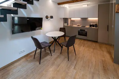 a kitchen and dining room with a table and chairs at Marvelės 30 Lofts in Kaunas