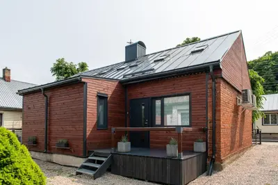 a wooden house with a metal roof at Marvelės 30 Lofts in Kaunas