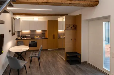 a kitchen and dining room with a table and chairs at Marvelės 30 Lofts in Kaunas