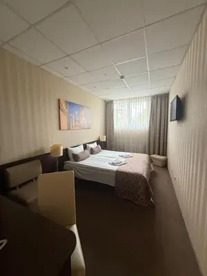 a hotel room with a bed and a couch at Naujamiescio Studio 305 in Vilnius