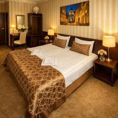 a bedroom with a large bed in a hotel room at Naujamiescio Studio 307 in Vilnius