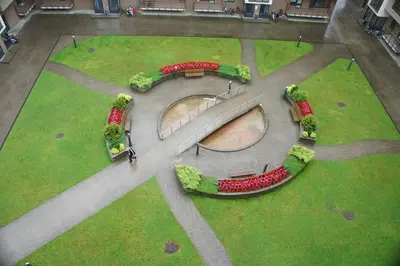 an aerial view of a park with a bridge and flowers at Lyra Apartments in Druskininkai