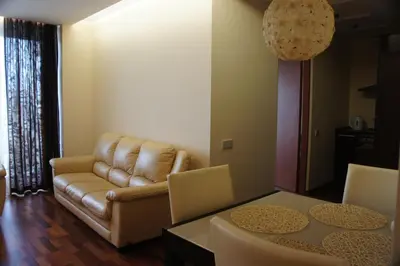 a living room with a couch and a table at Lyra Apartments in Druskininkai