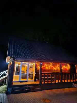 a small house with christmas lights on it at Sodyba Prie Maluno in Salakas