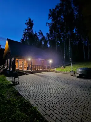 a building at night with lights in the background at Sodyba Prie Maluno in Salakas