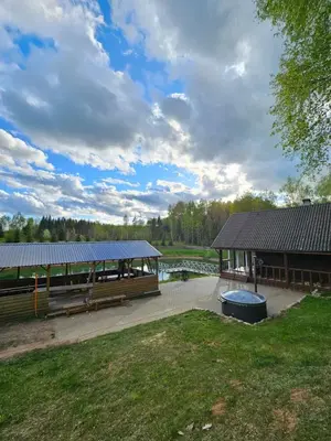 a pavilion with a picnic table in a park at Sodyba Prie Maluno in Salakas