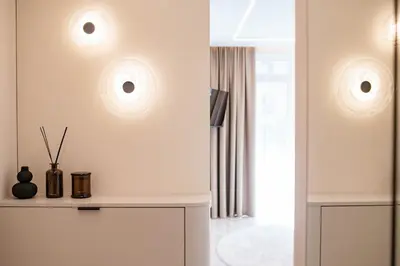 a living room with two lights on the wall at Stylish apartment next to the center in Vilnius