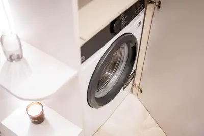 a washer and dryer in a room on an airplane at Stylish apartment next to the center in Vilnius