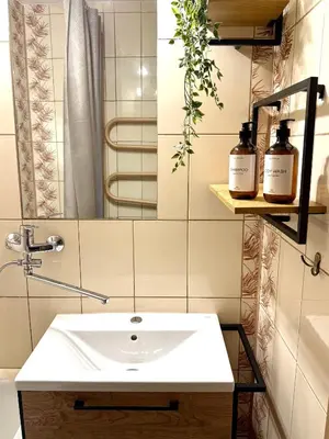 a bathroom with a sink and a mirror at Lake Town apartments in Zarasai