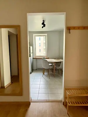 a kitchen and dining room with a table and a mirror at Lake Town apartments in Zarasai
