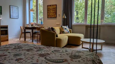 a living room with a couch and a table at Avenue Apartments in Kaunas
