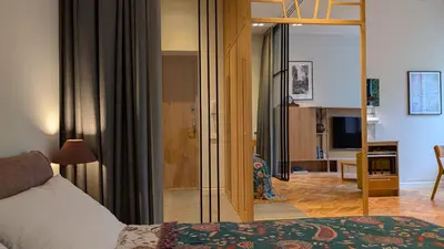 a hotel room with a bed and a sliding glass door at Avenue Apartments in Kaunas