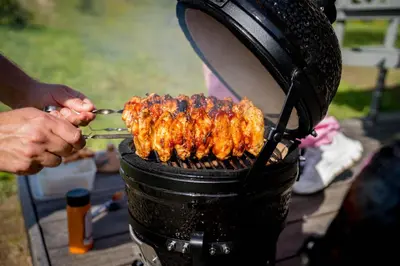 a person is cooking food on a grill at Briedžio sapnas in Sudervė