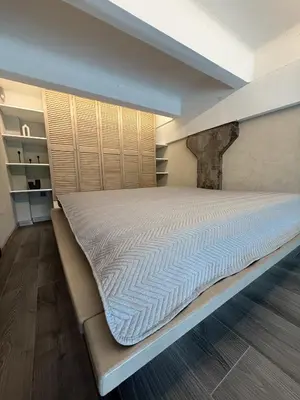 a large bed in a room with at Urban Breeze Kaunas in Kaunas