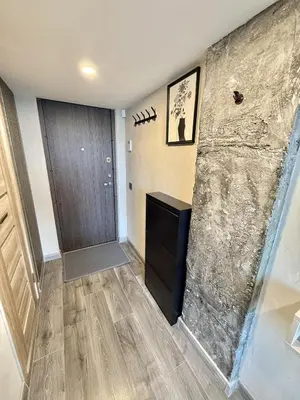 a room with a stone wall and a door at Urban Breeze Kaunas in Kaunas