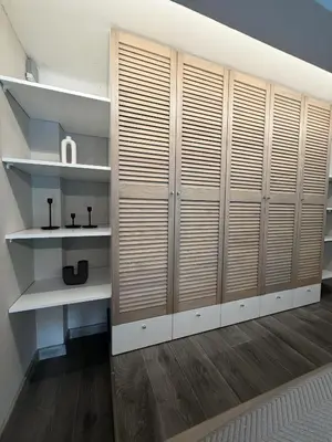 a room with white shelves and wooden dividers at Urban Breeze Kaunas in Kaunas