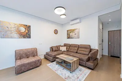 a living room with a couch and two chairs at Saulės Sonata apartamentai 5 in Druskininkai