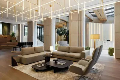 a living room with couches and a table at AC Hotel by Marriott Vilnius in Vilnius