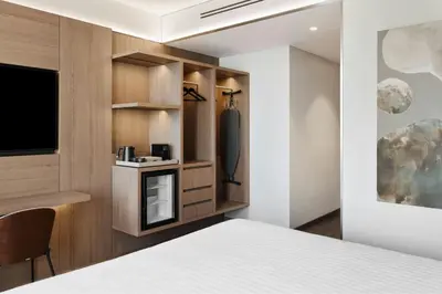 a hotel room with a bed and a tv at AC Hotel by Marriott Vilnius in Vilnius
