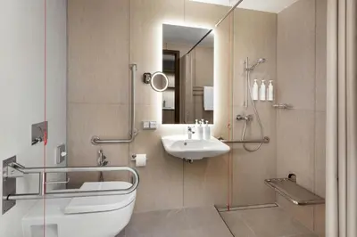 a bathroom with a sink and a shower at AC Hotel by Marriott Vilnius in Vilnius
