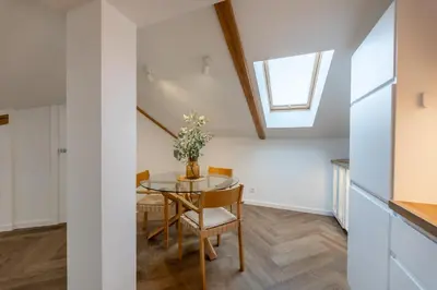a room with a table and chairs and a window at Griunvaldo apartamentai in Kaunas
