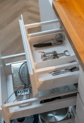 a kitchen drawer with a sink and utensils at Griunvaldo apartamentai in Kaunas