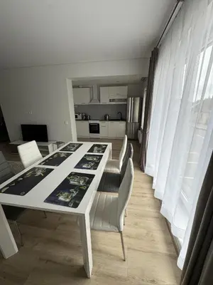 a white table and chairs in a room at Florina namai in Marijampolė